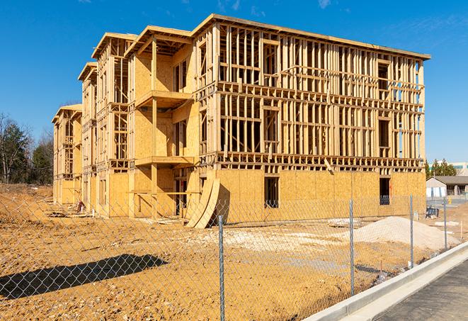 a close-up of temporary chain link fences enclosing a job site, signaling progress in the project's development in Mead